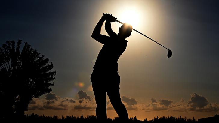 Golfer teeing off silhouette